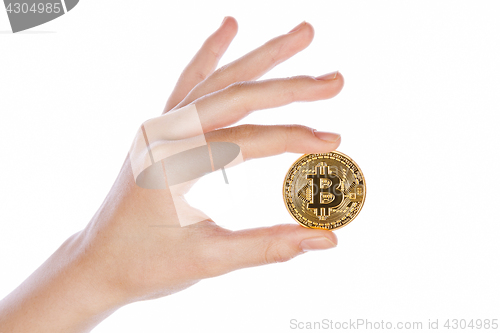 Image of Young girl hand holding bitcoin on white 