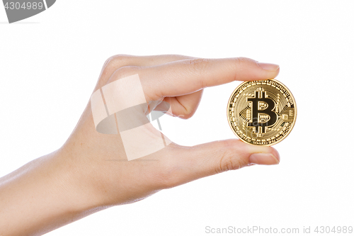 Image of Young girl hand holding bitcoin on white 
