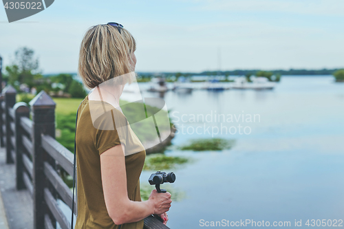 Image of Woman capturing herself with personal camera