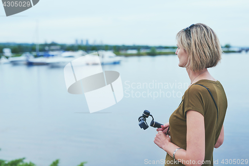 Image of Woman capturing herself with personal camera