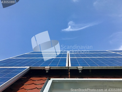 Image of House roof with solar panels on top