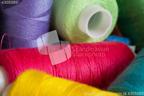 Image of Pile of coloured bobbins of thread