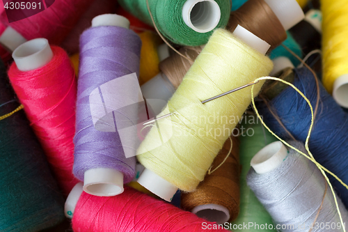 Image of Pile of coloured bobbins of thread