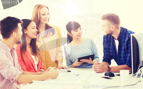 Image of happy creative team or students working at office