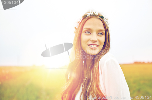 Image of smiling young hippie woman on cereal field