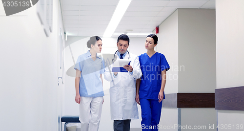 Image of group of medics at hospital with clipboard