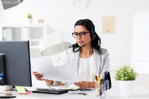 Image of businesswoman with headset and computer at office