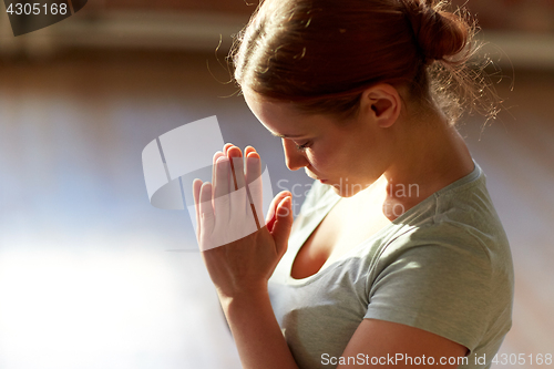 Image of close up of woman meditating at yoga studio