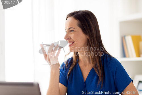 Image of woman using voice recorder on smartphone at office