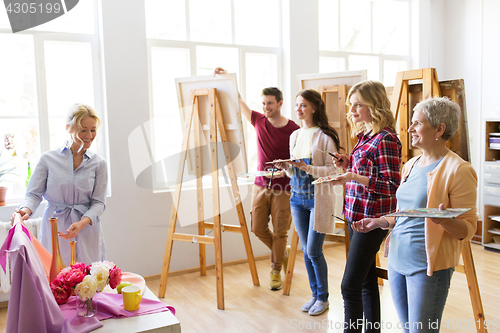 Image of students and teacher with still life at art school