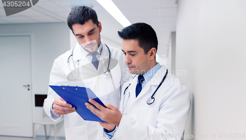 Image of two male doctors with clipboard at hospital