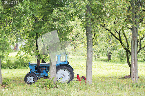 Image of Old Russian tractor in the garden