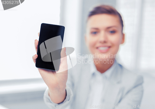 Image of businesswoman with smartphone in office
