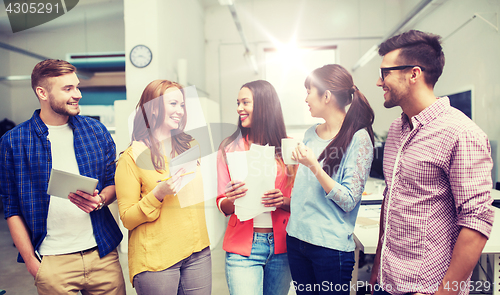 Image of creative team on coffee break talking at office