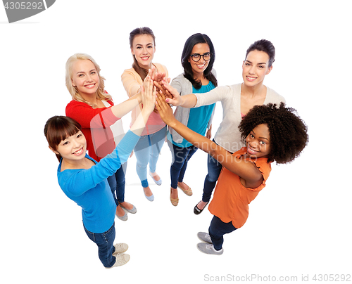 Image of international group of happy women doing high five