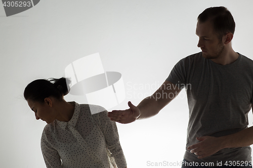 Image of couple having fight and man slapping woman