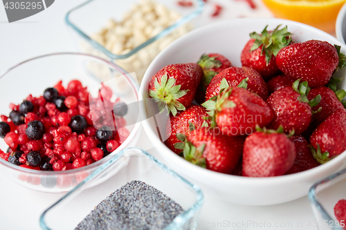 Image of fruits and berries in bowls on table