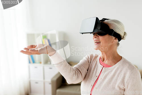 Image of old woman in virtual reality headset or 3d glasses