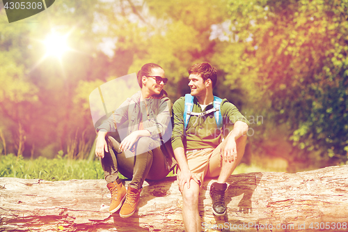 Image of smiling couple with backpacks in nature