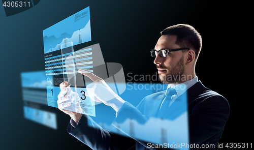 Image of businessman with tablet pc and exchange charts