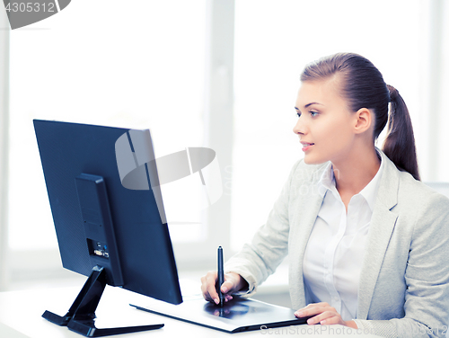 Image of businesswoman with drawing tablet in office