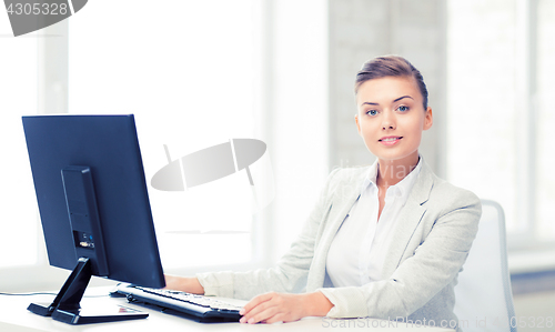 Image of businesswoman with computer in office