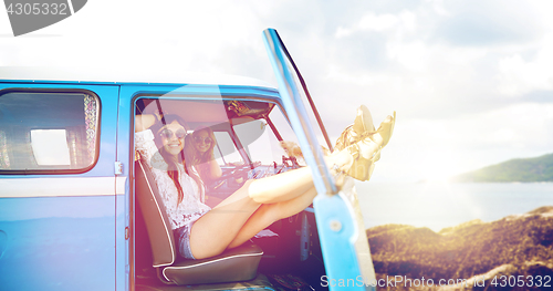 Image of happy hippie women in minivan car on summer beach