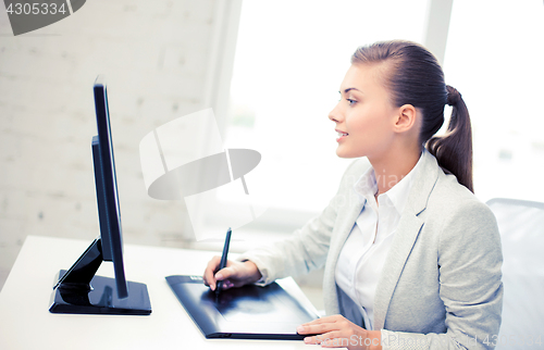 Image of businesswoman with drawing tablet in office