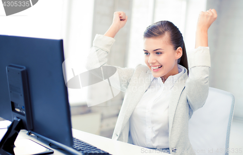 Image of businesswoman with computer in office