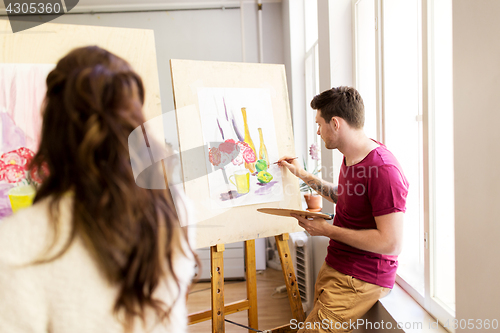 Image of artists painting still life picture at art school