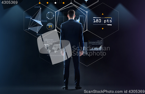 Image of businessman looking at virtual screen from back