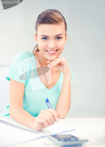 Image of student girl with notebook and calculator