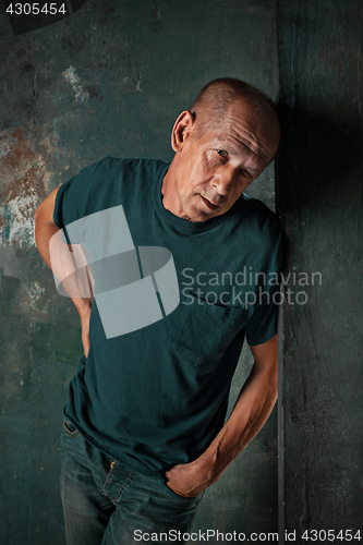 Image of Worried mature man standing at studio