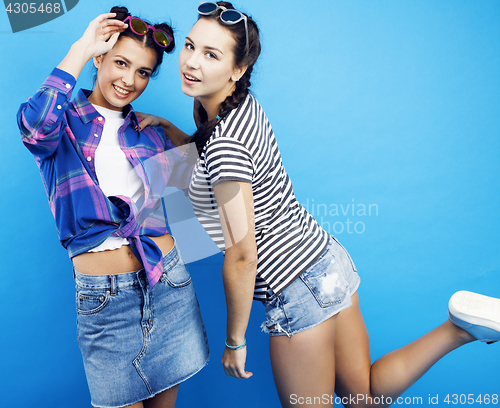 Image of best friends teenage school girls together having fun, posing emotional on blue background, besties happy smiling, lifestyle people concept 