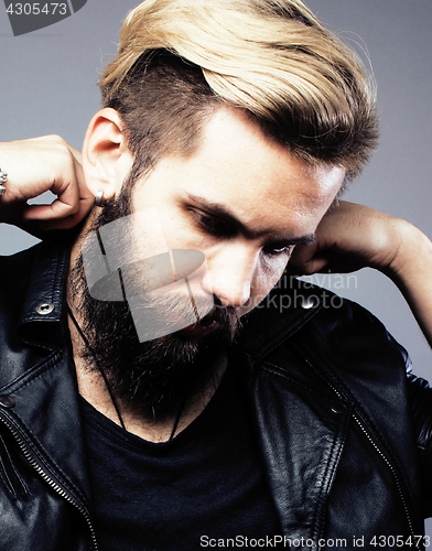 Image of portrait of young bearded hipster guy on gray dark background close up, brutal modern man, lifestyle people concept 