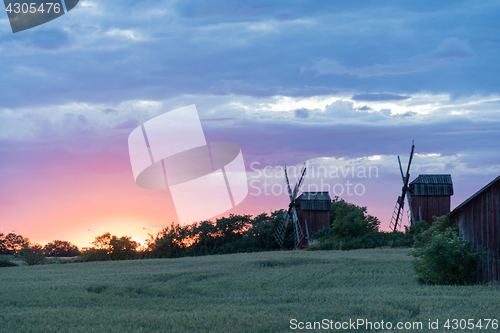 Image of Old windmills by sunset