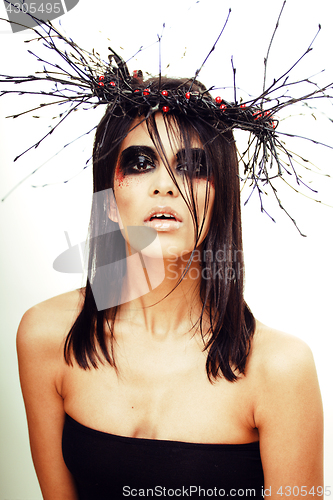 Image of pretty brunette woman with make up like demon at halloween