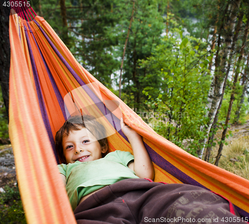 Image of little cute boy in hammock smiling