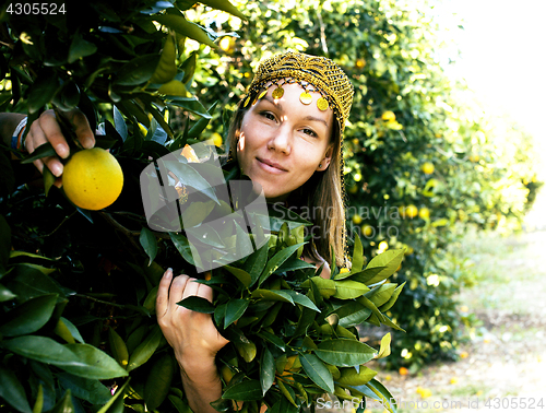 Image of pretty islam woman in orange grove smiling