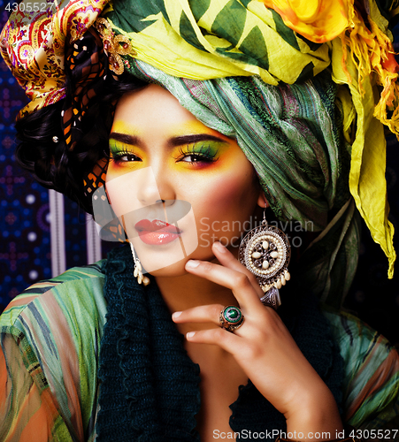 Image of beauty bright woman with creative make up, many shawls on head like cubian, ethno 