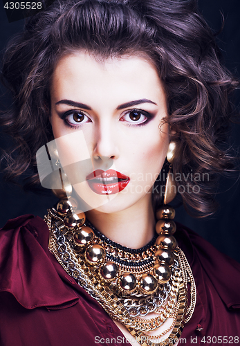 Image of beauty rich brunette woman with a lot of jewellery