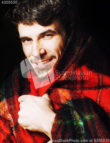 Image of portrait of handsome man warmed up in scarf christmas colored