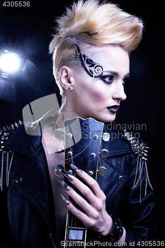 Image of Fashion Rocker Style Model Girl Portrait. Hairstyle. Punk Woman Makeup, Hairdo and black Nails. Smoky Eyes