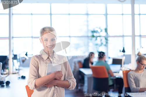 Image of woman working on digital tablet in night office