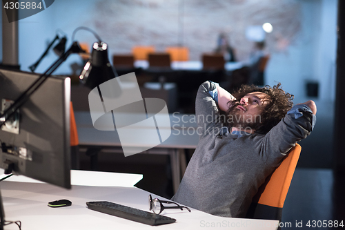 Image of businessman relaxing at the desk