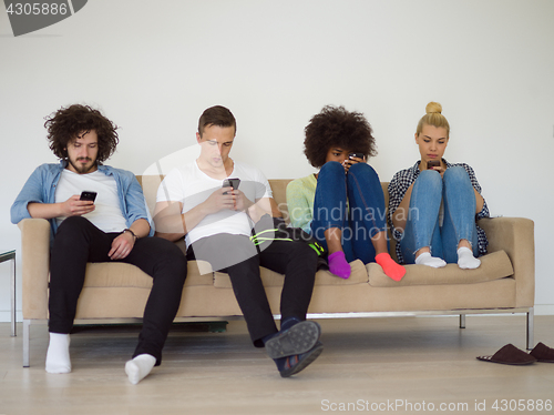 Image of multiethnic group of young people staring at smartphone