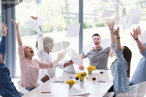 Image of multiethnic startup Group of young business people throwing docu