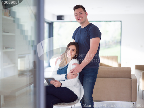 Image of couple using tablet at home