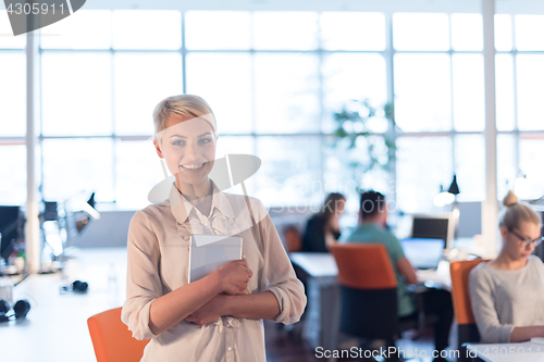 Image of woman working on digital tablet in night office