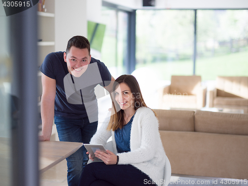 Image of couple using tablet at home